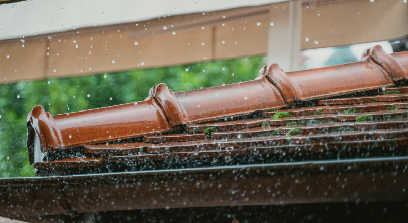 Telhado de casa durante dia chuvoso representando a importância da manutenção preventiva antes das chuvas de verão
